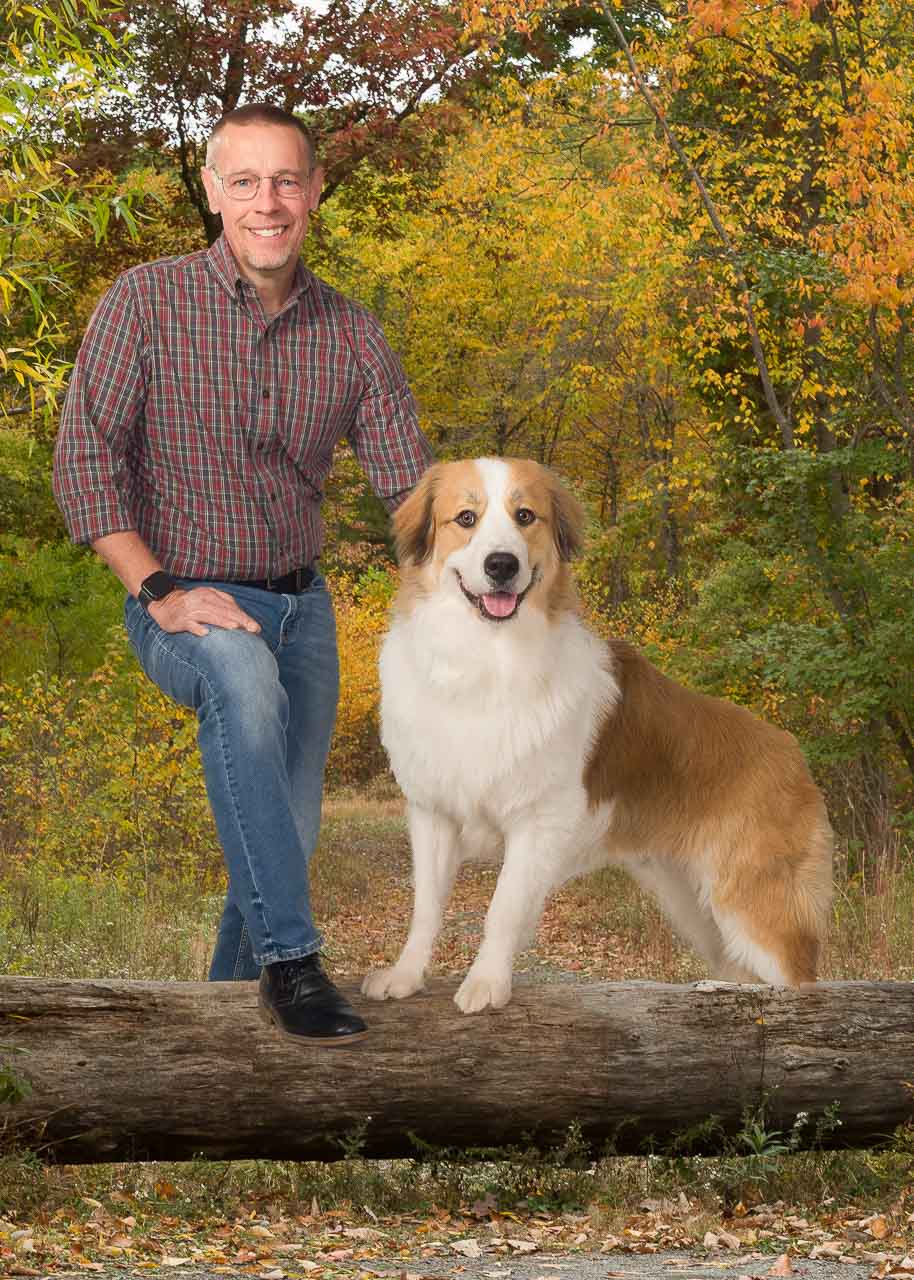 A man and his dog posing for the camera.